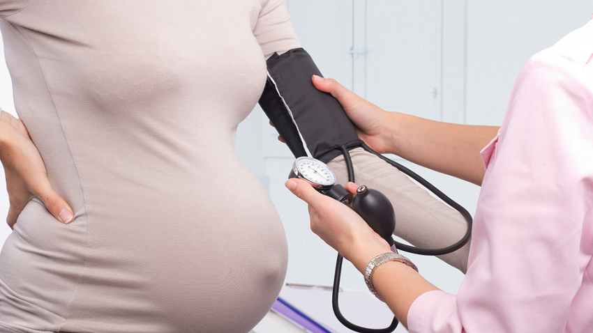 Pregnant woman getting her blood pressure taken