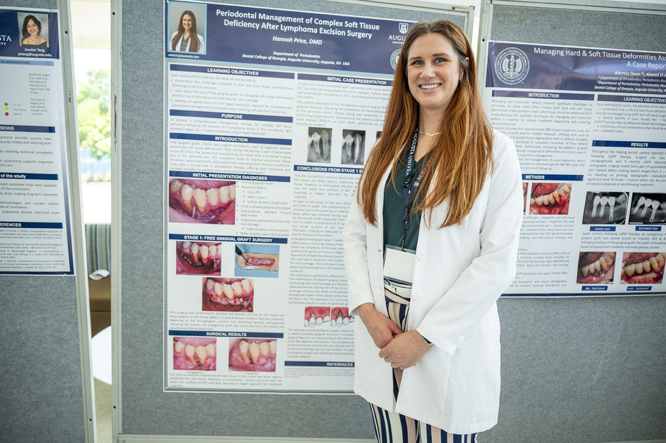 A female dental resident smiles in front of a poster of her research.