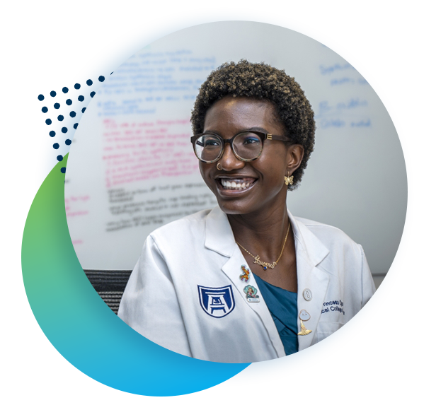 Healthcare student in front of a whiteboard smiles