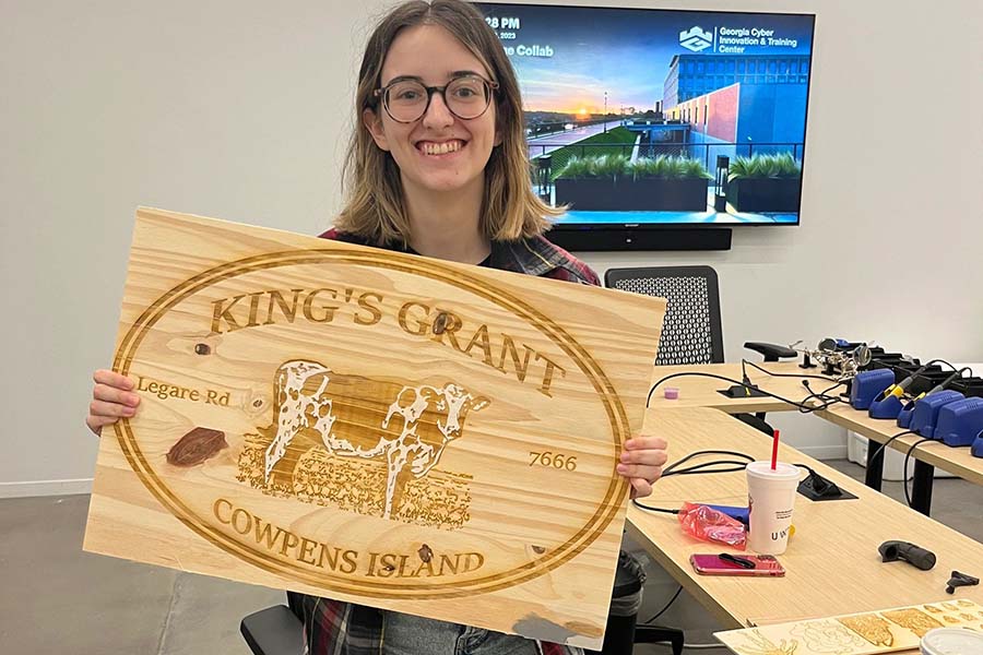 girl with wooden engraved sign