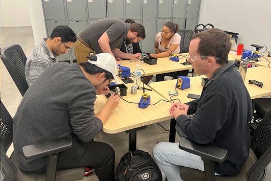 The Garage Makerspace Group of students soldering electronics in The Garage