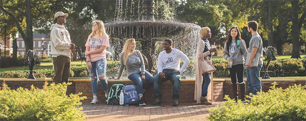 Students standing around the fountain