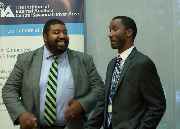 Two men smiling and talking together