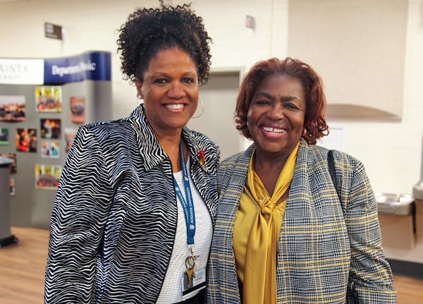 Two women posing together smiling