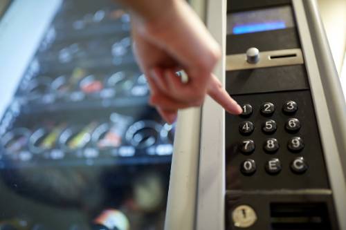 Finger making a selection at a vending machine