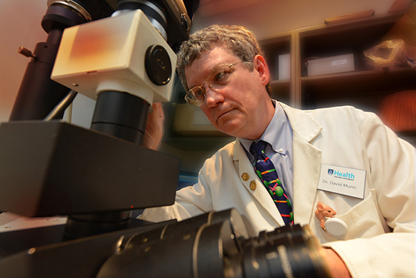 Scientist working with a machine in a research lab