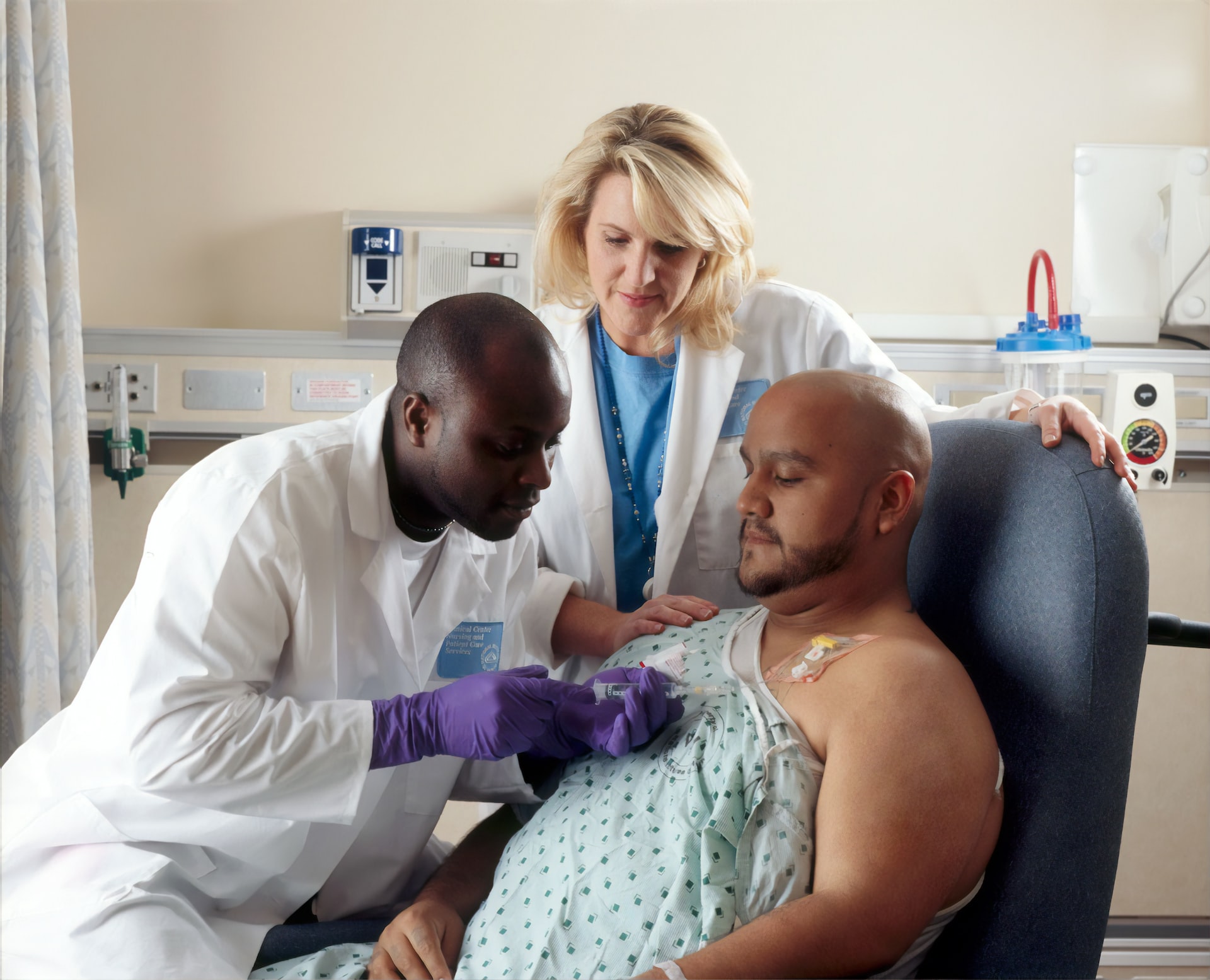 Doctor and nurse with patient in medical gown