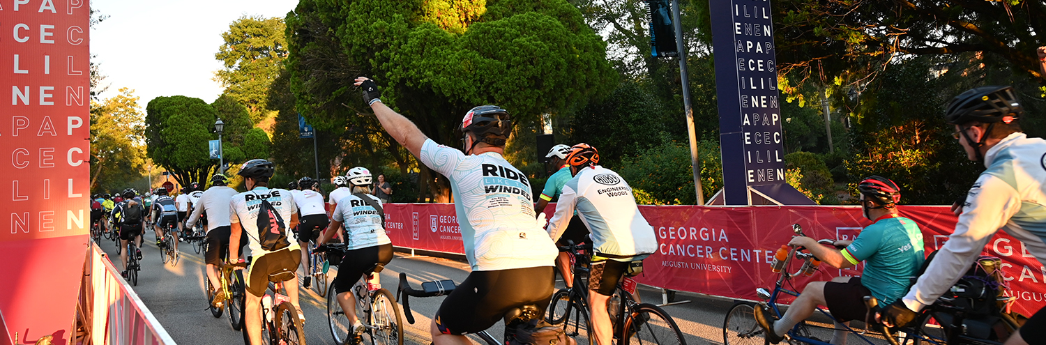 Paceline participants riding bicycles down the street