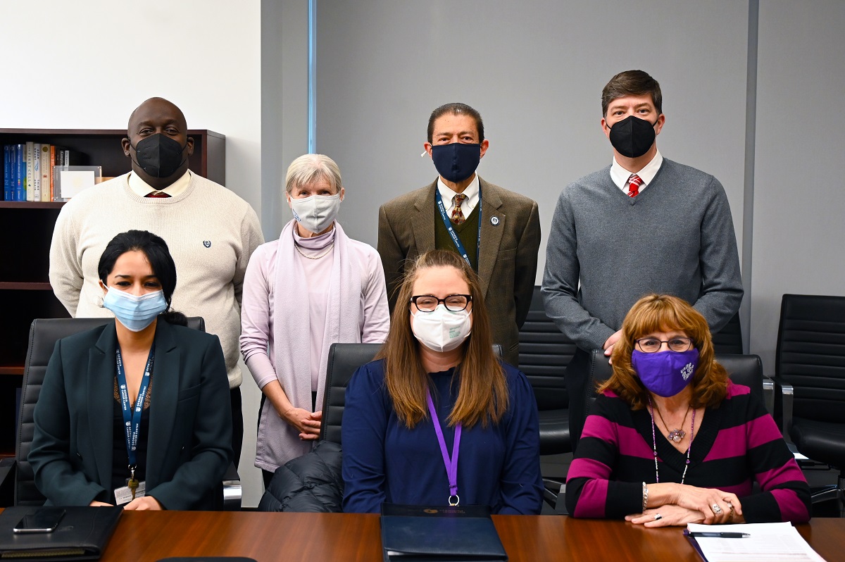 People standing and sitting in conference room