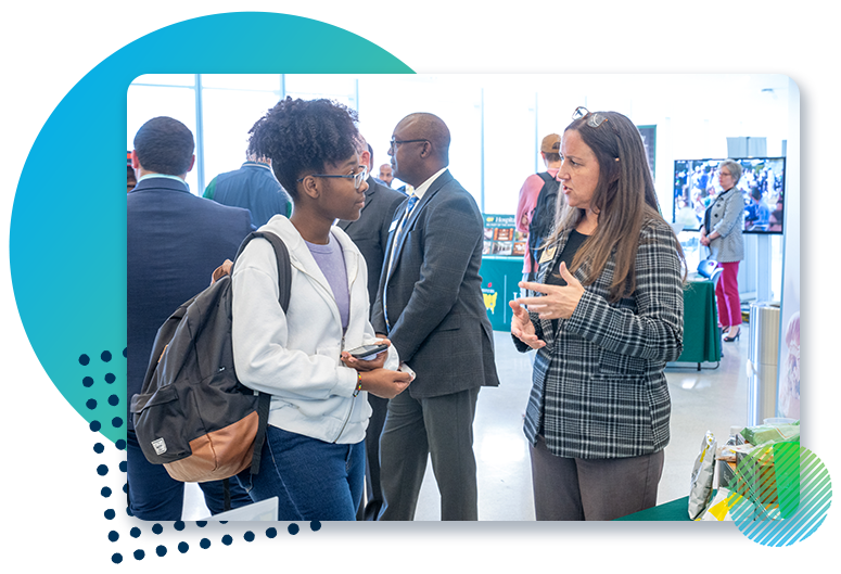 Student talking to employer at career fair