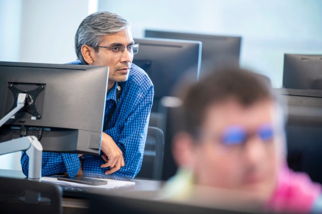 man in front of a computer monitor