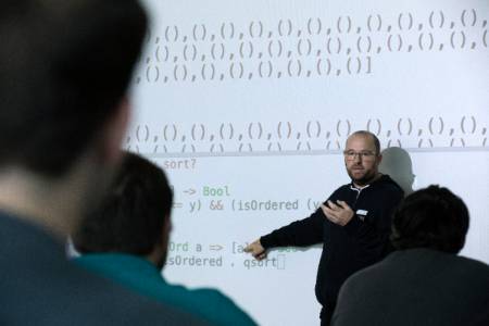 professor in front of projector