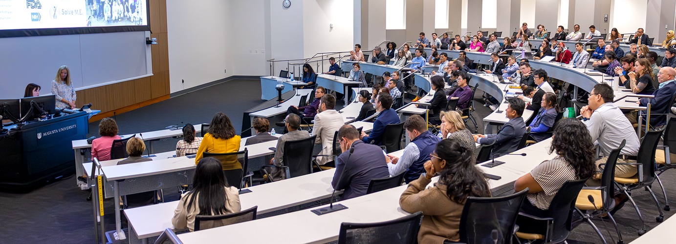 People in audience listening to a lecture