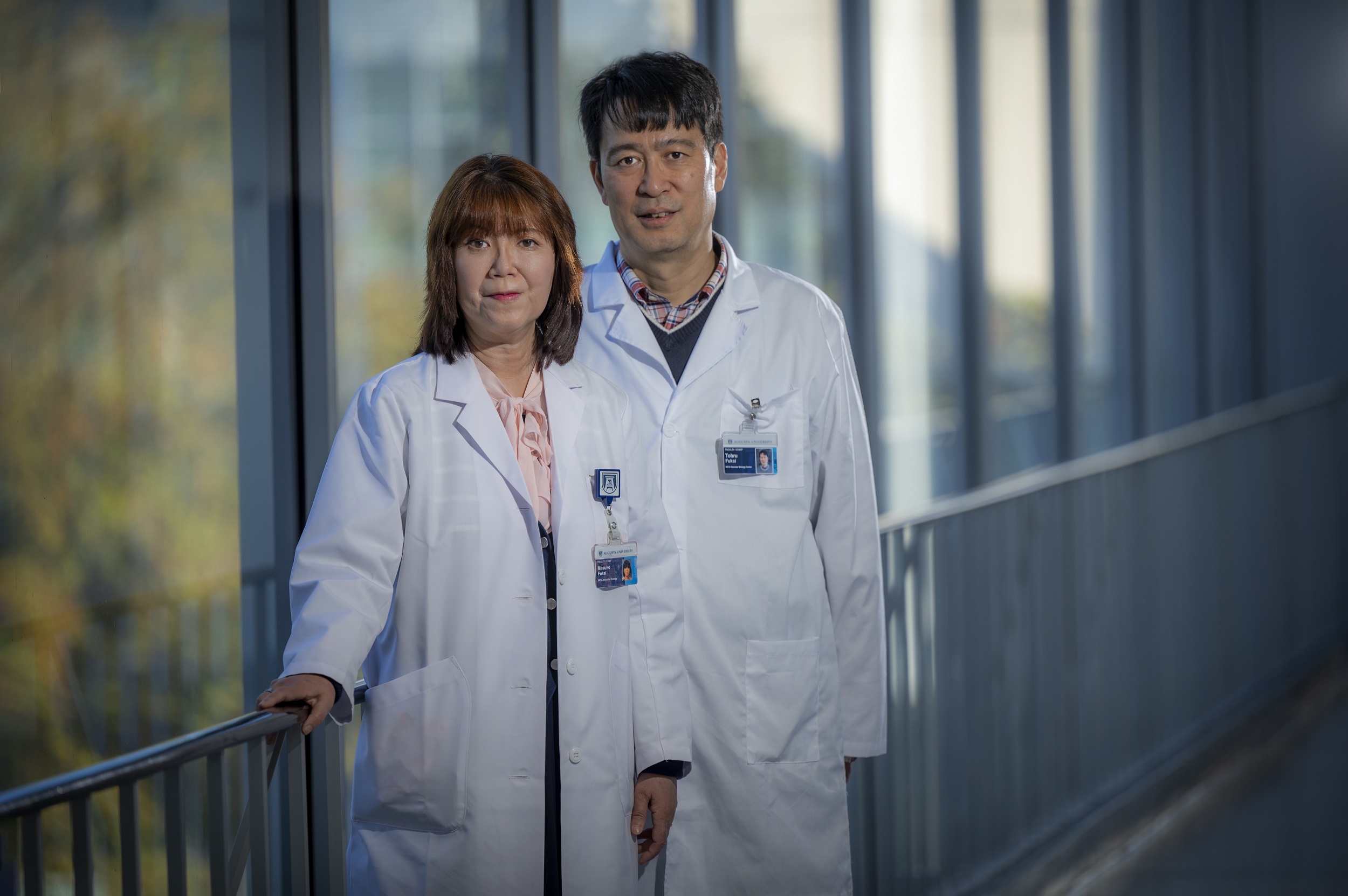 Drs. Tohru andMasuko Fukai posing for camera in hallway