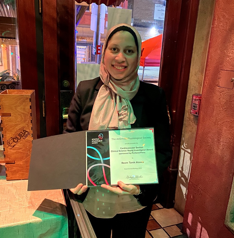 Reem Tarek Atawia stands with her award