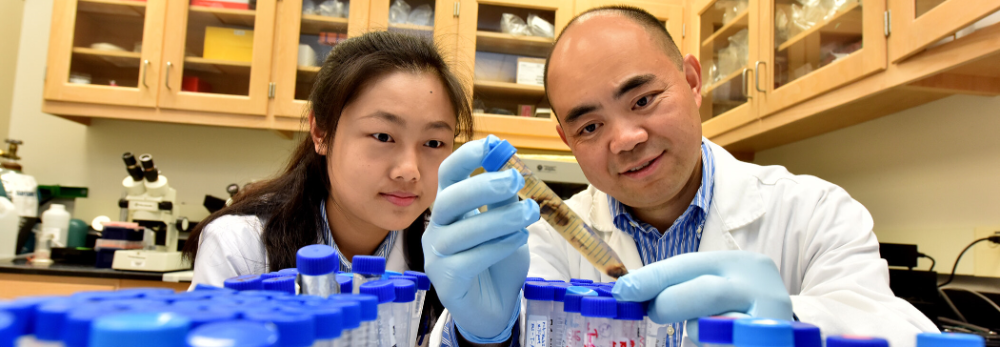 vbc promo with two researchers looking at vials