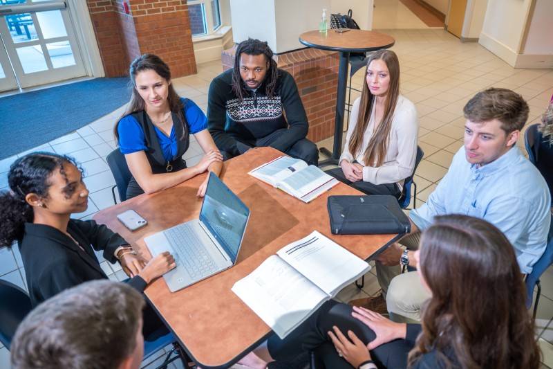 male and female students sitting at a table