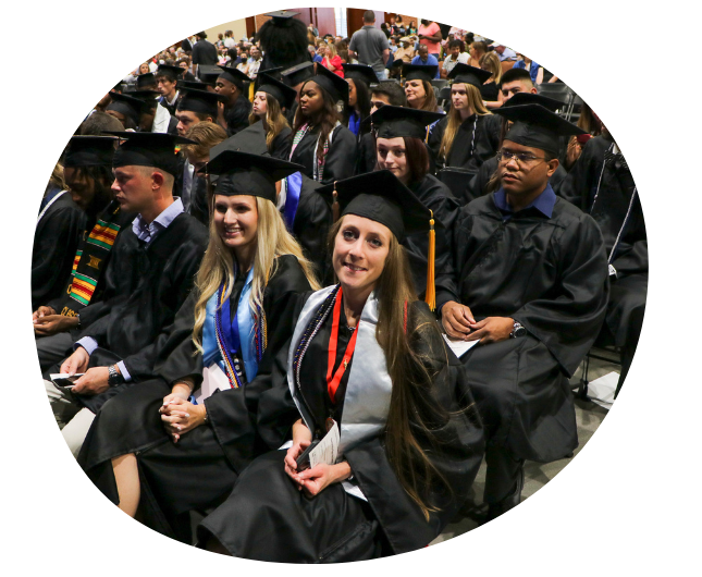 students sitting at commencement