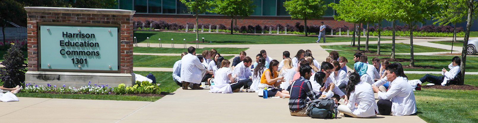 MCG students sitting eating outside Harrison Commons