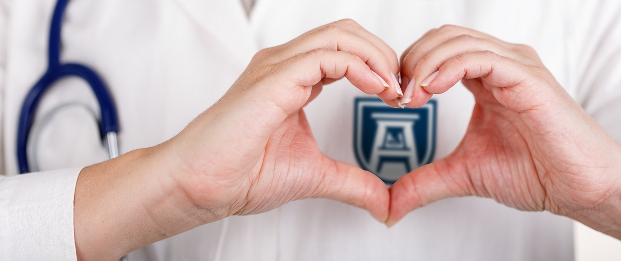Hands making heart shape over AU Logo