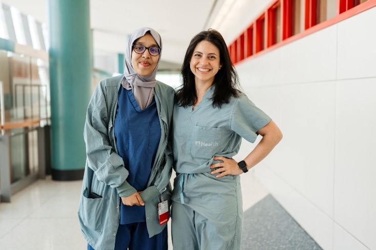 two women smile at the camera