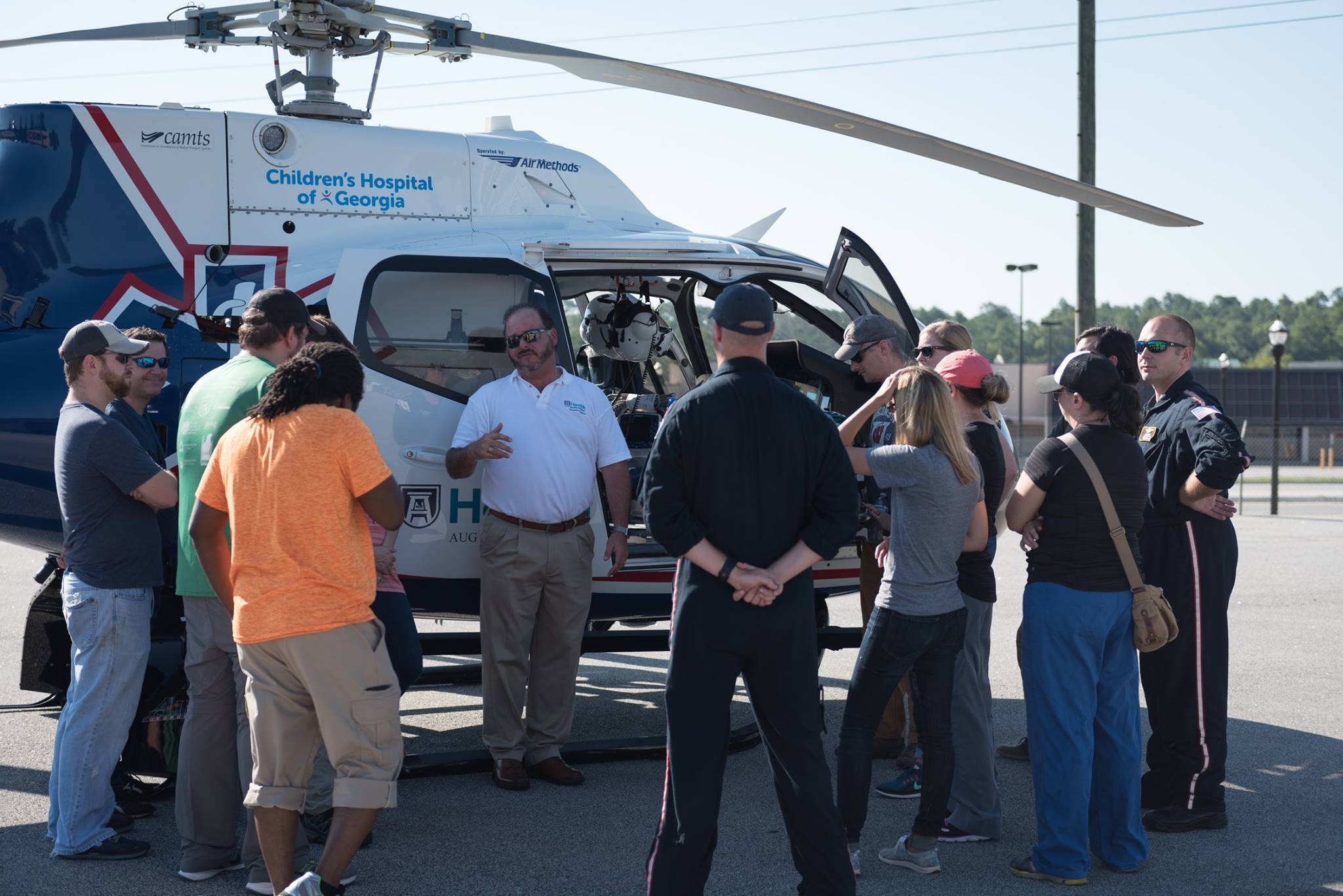 Dr. Phillip Coule explaining advantages and challenges of helicopter transport to residents.