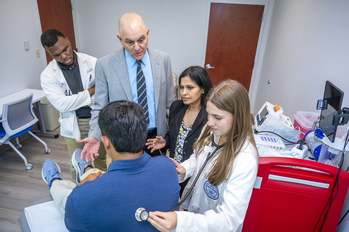 Student with patient and teachers
