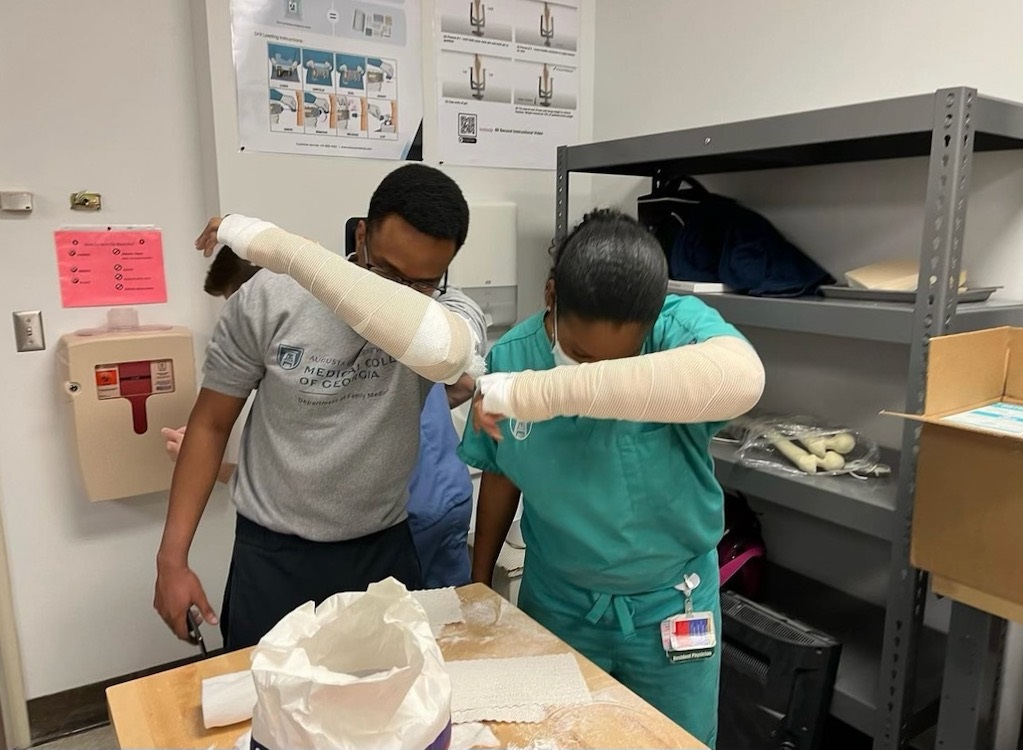 Residents celebrate a successful arm cast demonstration