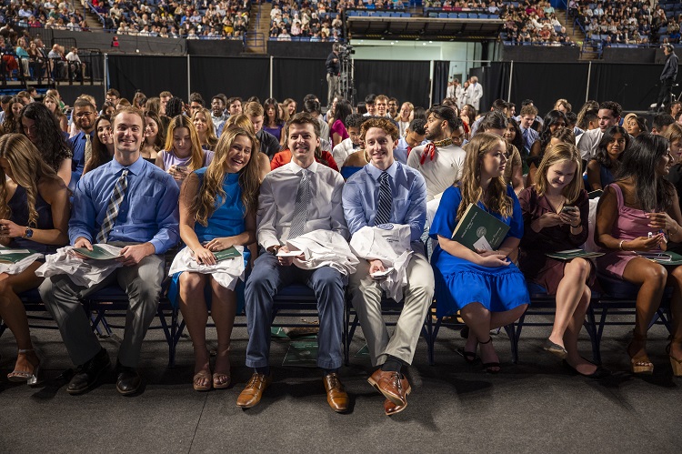 Group of young adults sitting at White Coat Class of 2027