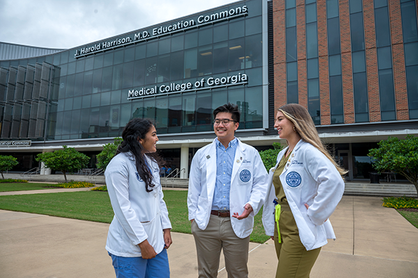 MCG Students standing outside of the J. Harold Harrison, M.D. Education Commons building