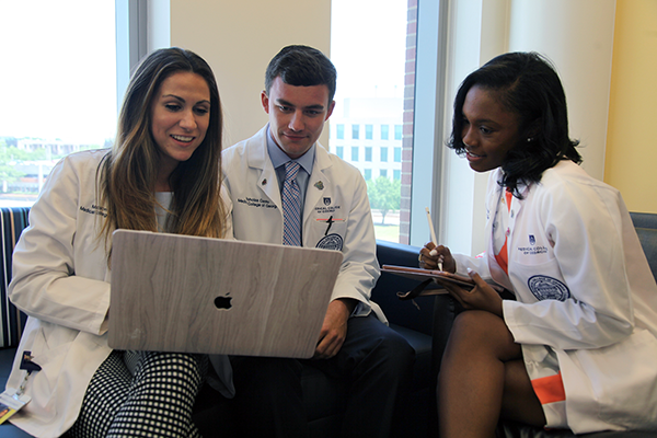 Students looking at a laptop computer