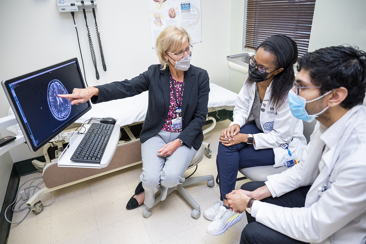 Neurology faculty looking at computer