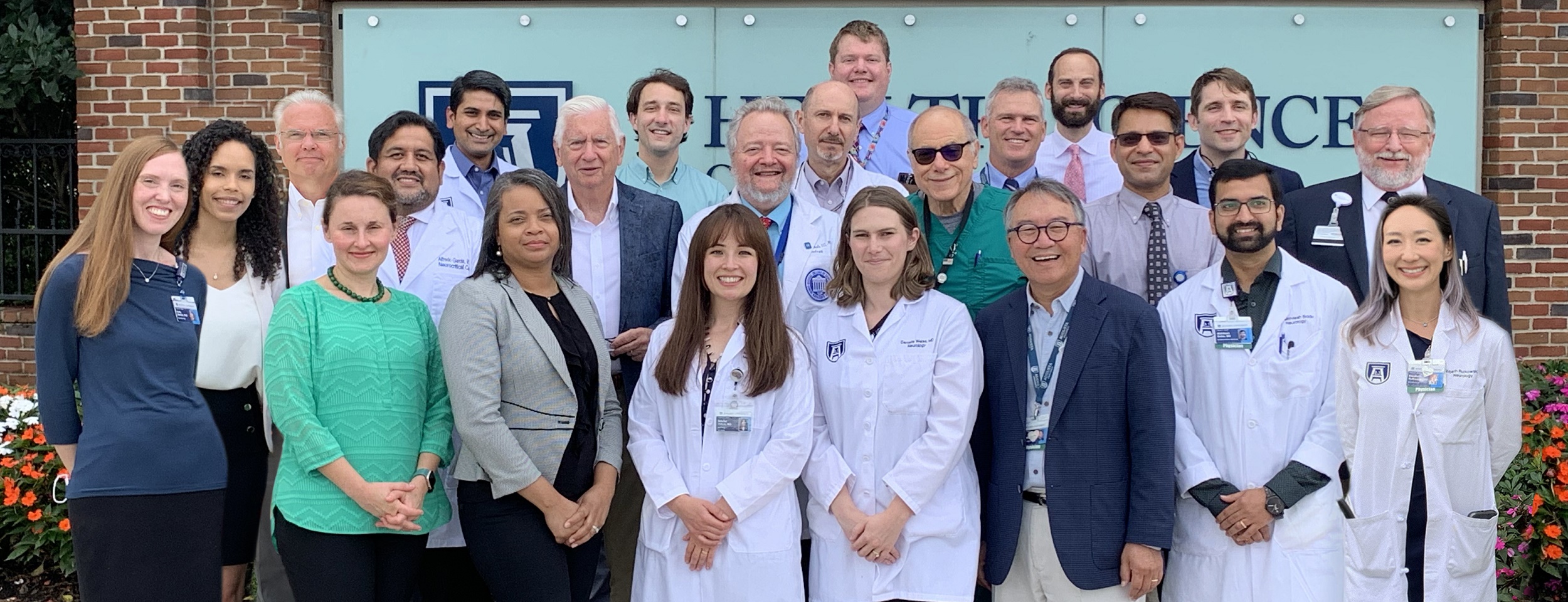 Neurology Faculty in front of sign image