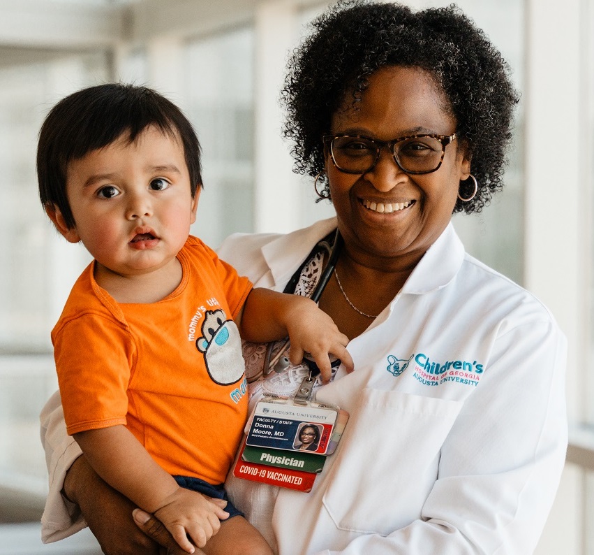 Dr. Moore holding patient in hallway