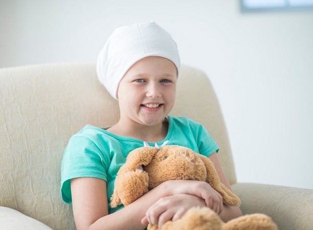 Young girl with leukemia smiles for camera