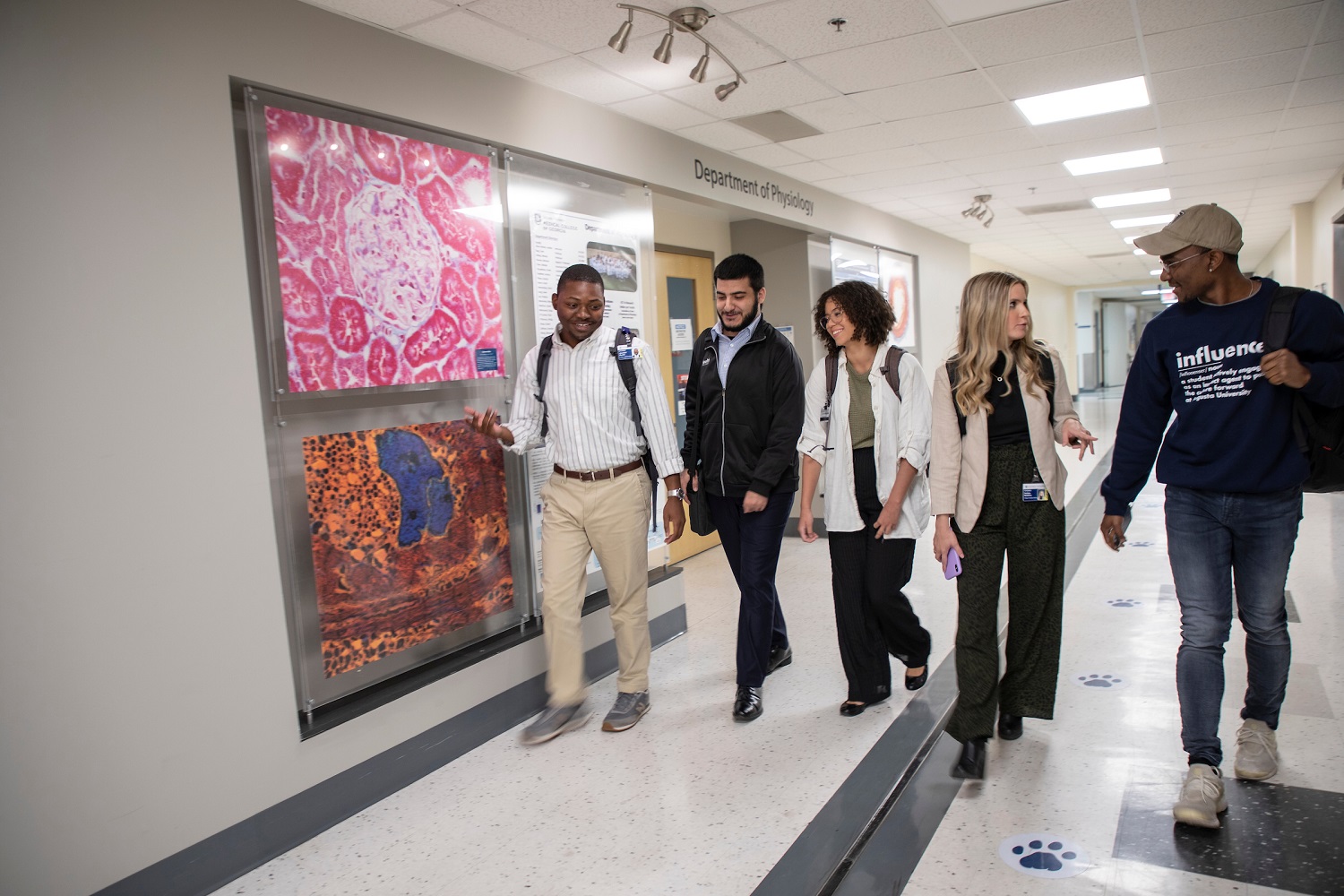 Master of Science promotional image- students walking in hall