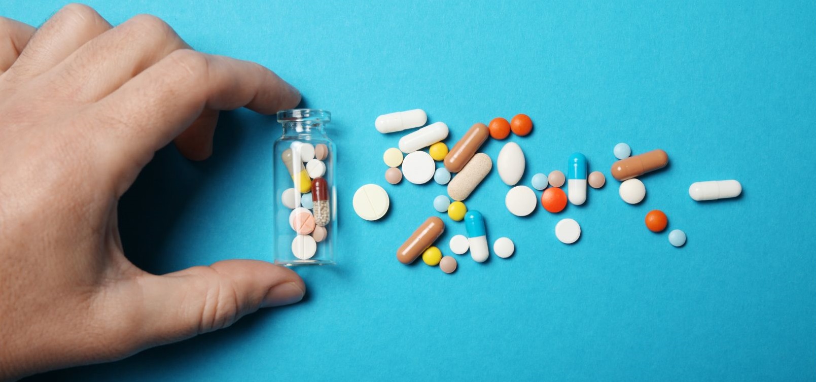 hand next to various pills