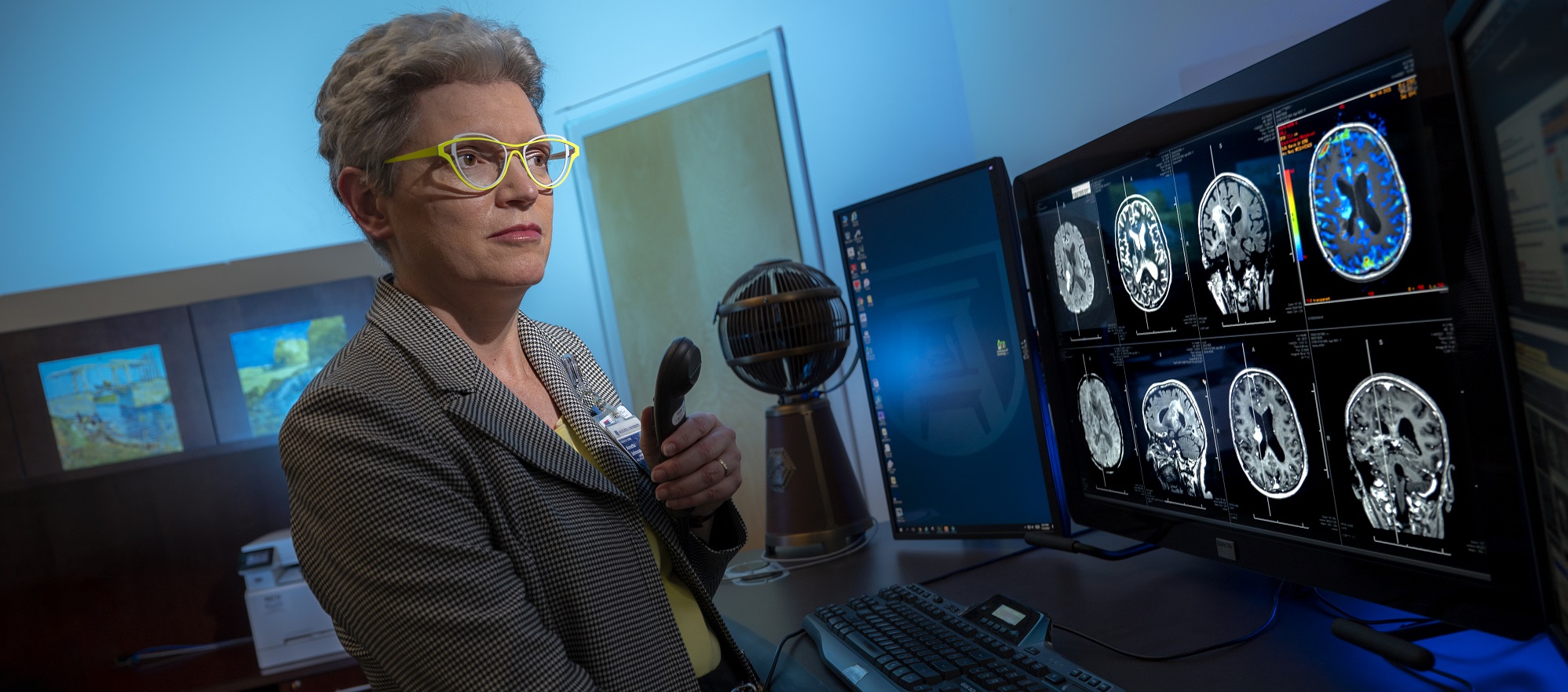 woman stands in front of computer screens