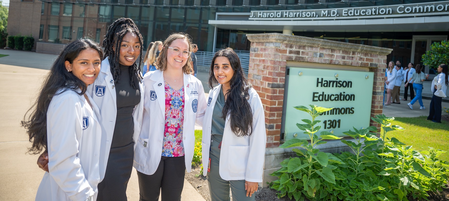 MCG students pose in front of Harrison Commons building