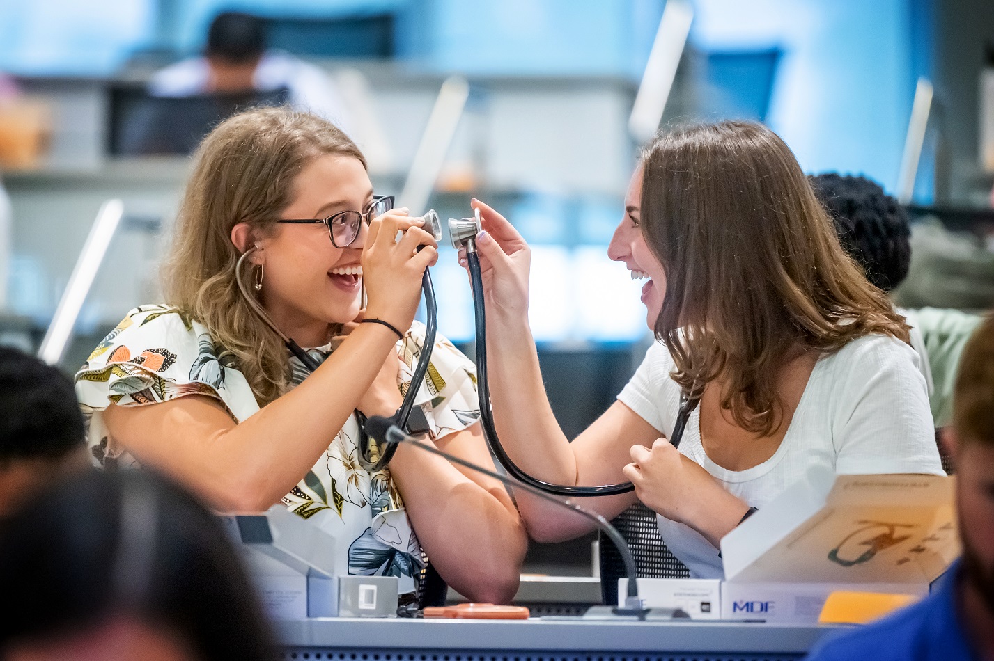 Freshman play with their newly opened stethoscopes