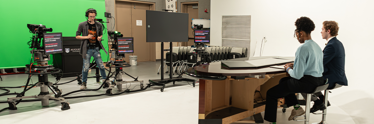 Communication students sitting in a video recording studio