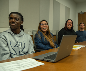 four students looking up with joy