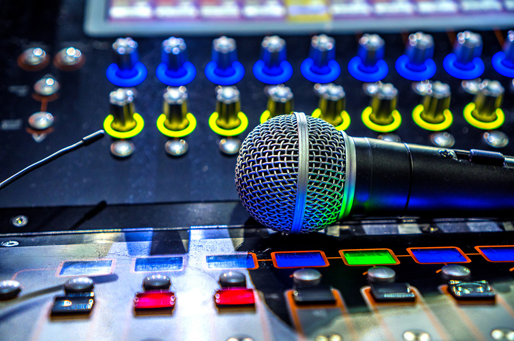 Microphone laying on top of audio equipment