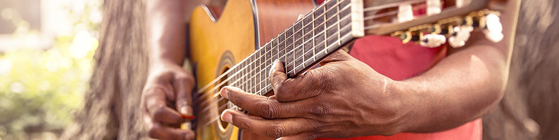 Young man playing guitar outdoors