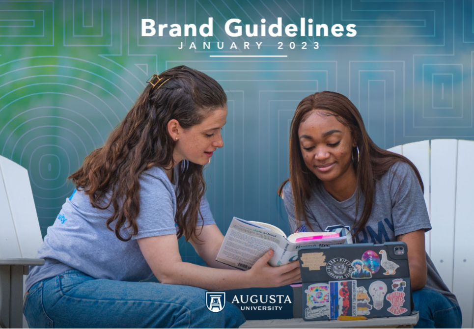 two girls looking at a book with the words brand guidelines january 2023 on the top