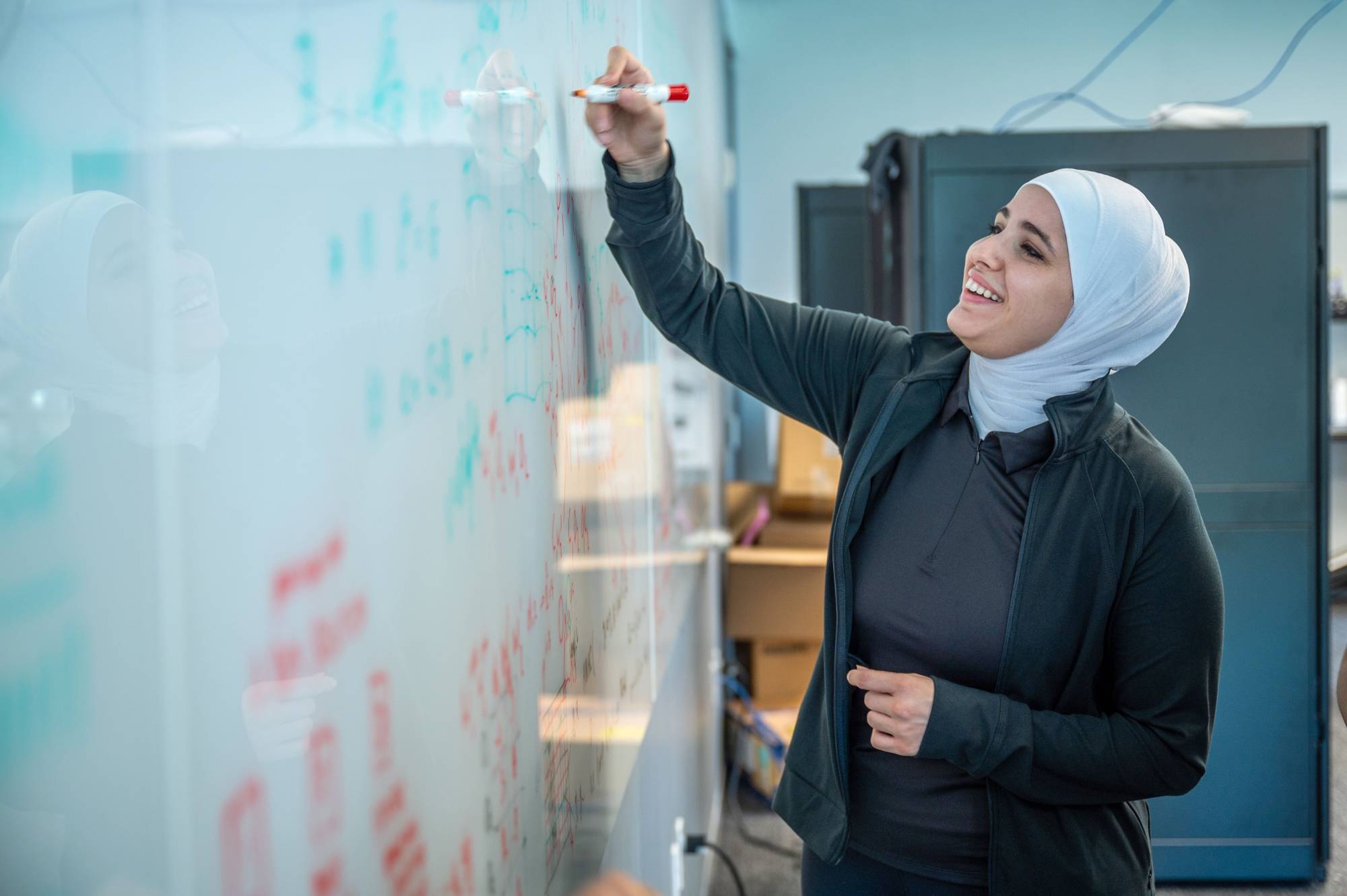 woman writing on board