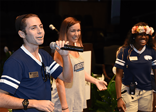 Leaders at Freshman Convocation speaking into microphones on stage