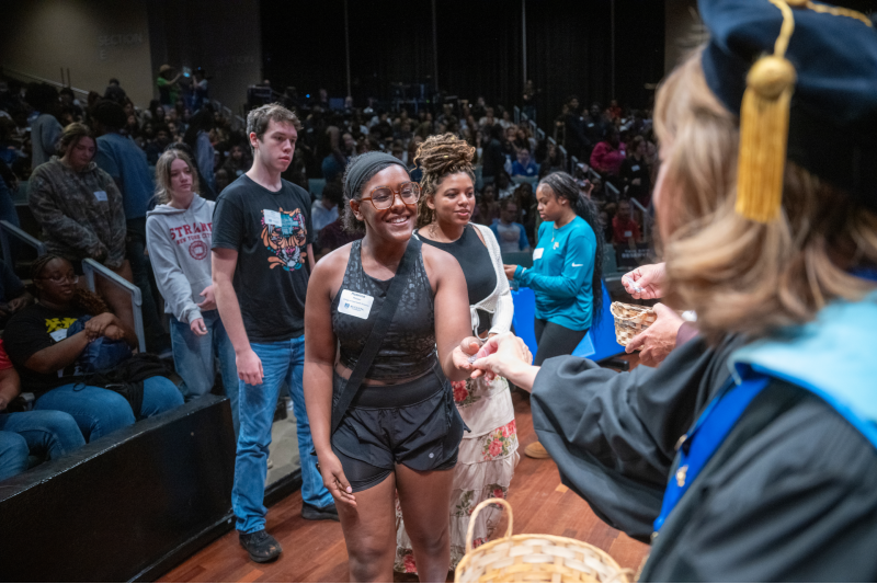 a woman smiling with her hand out at another woman