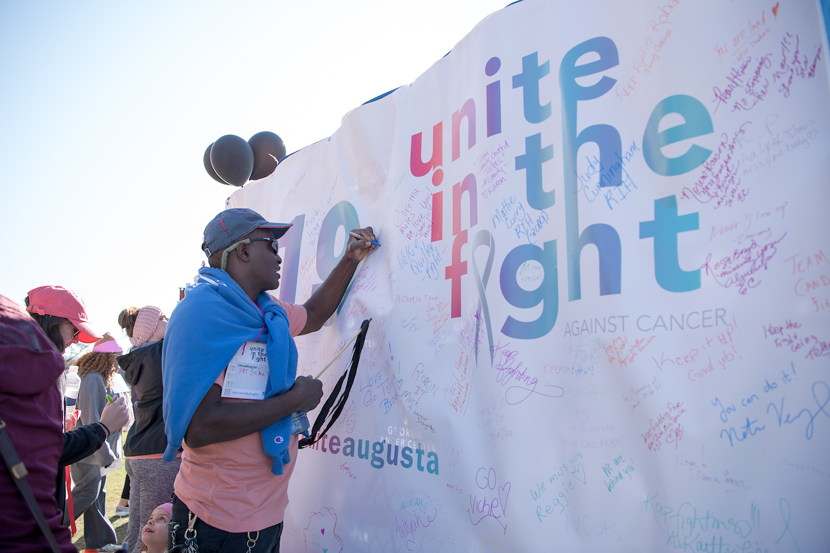 person signing banner