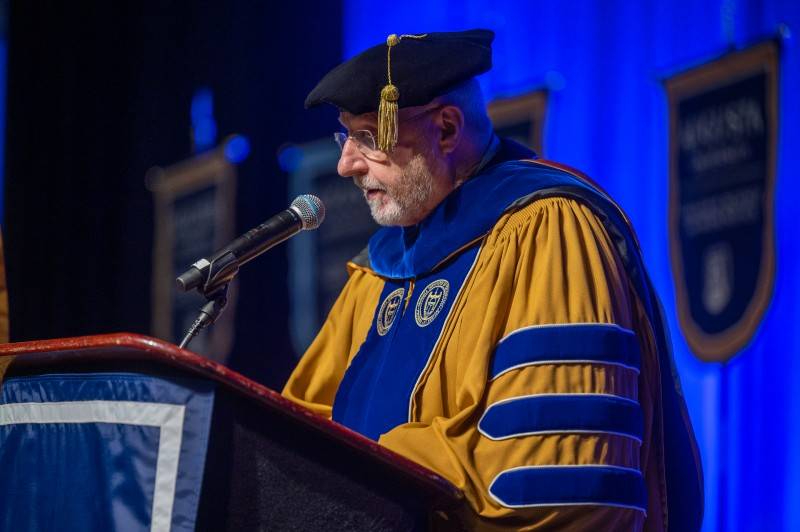 man speaking at podium